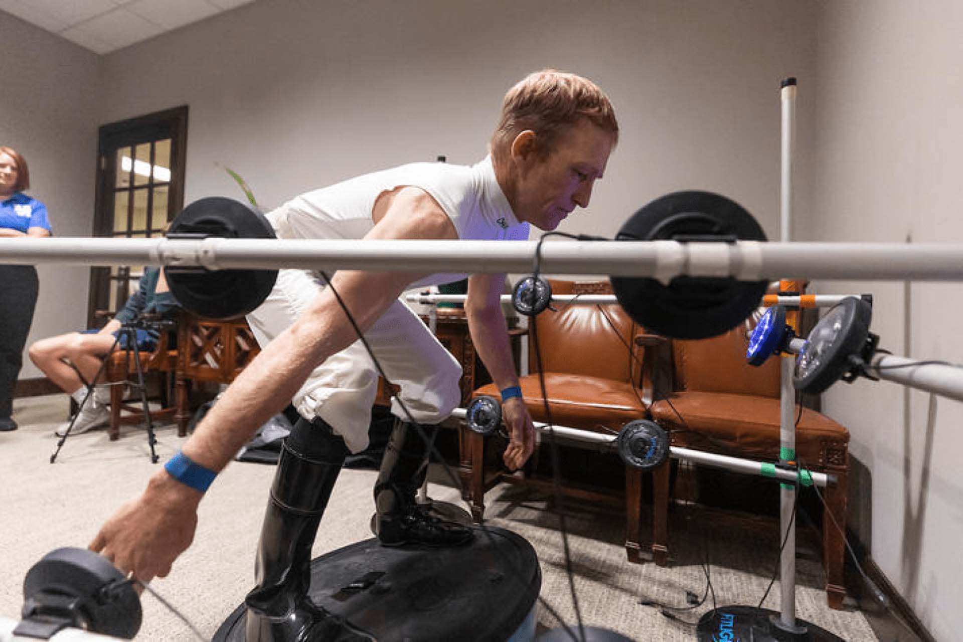 An action shot of a jockey crouching as he balances on a piece of training equipment.